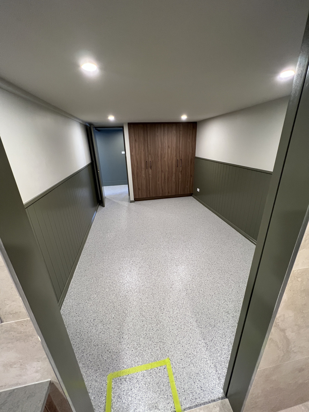 Home entertainment space with decorative flake epoxy floor