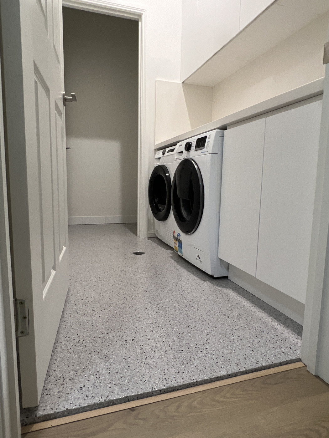 Residential laundry with grey flake epoxy floor